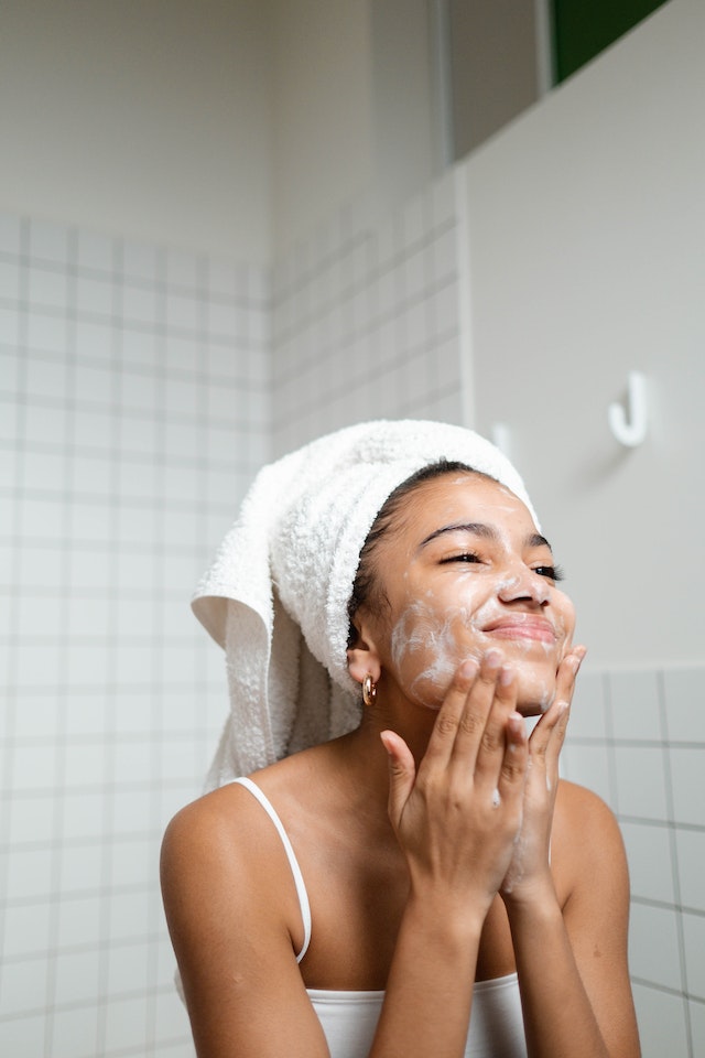Woman happily washing face
