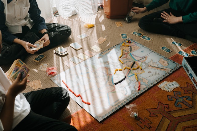 groups of people playing a board game together