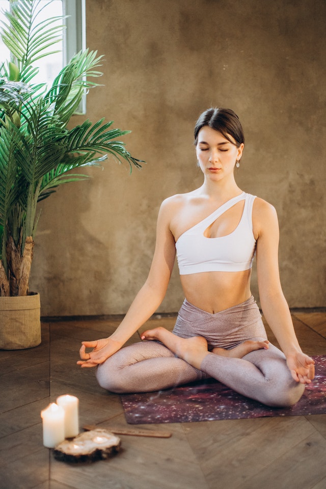 woman meditating in lotus position