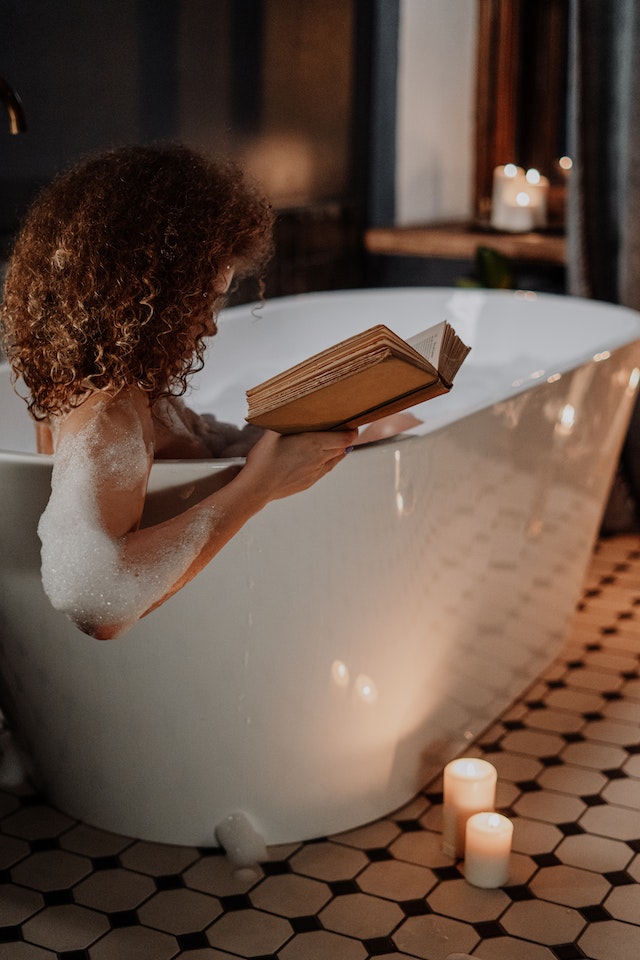 woman reading in bath