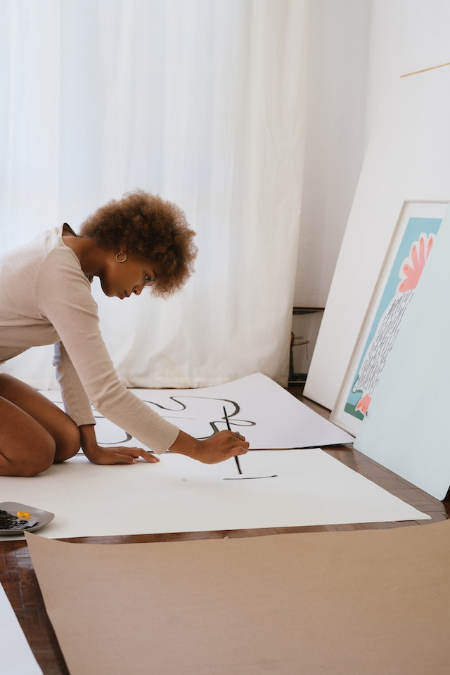 woman painting as part of self-care challenge