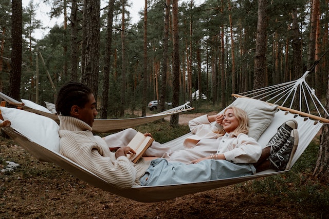 couple reading in hammock together