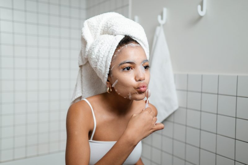 Busy woman taking a moment for self-care with a face mask