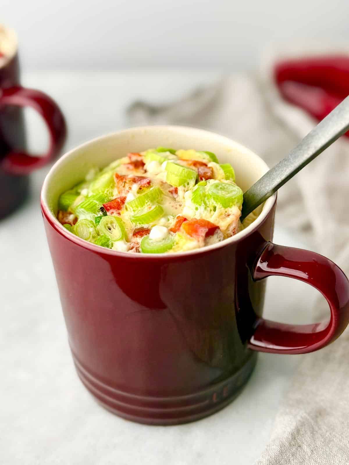 Microwave egg white omelet in a red mug with vegetables