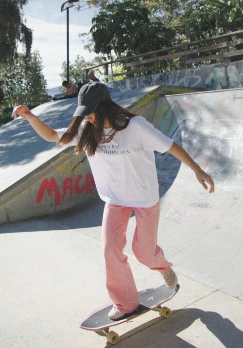 Woman in her 20s skateboarding at a skatepark, embracing an active and adventurous hobby.