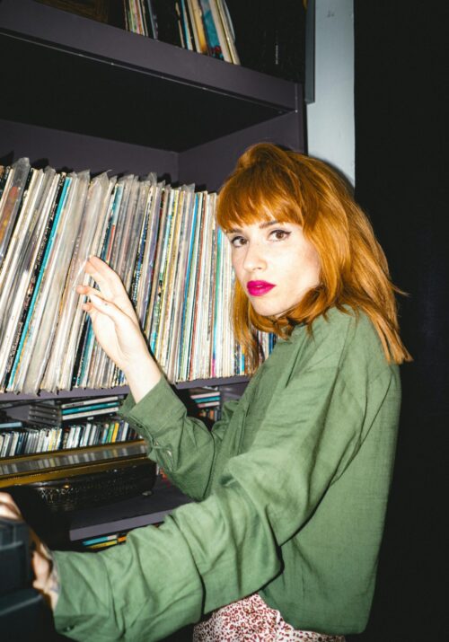 woman in her 30s looking through vinyl records, a great hobby for women in their 30s