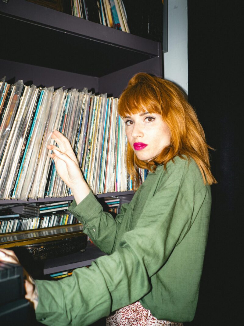 woman in her 30s looking through vinyl records, a great hobby for women in their 30s