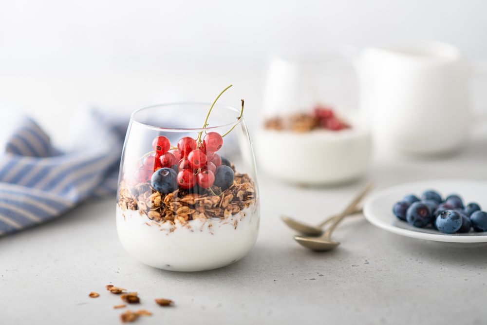 Low carb high protein breakfast parfait with yogurt, granola, and berries.