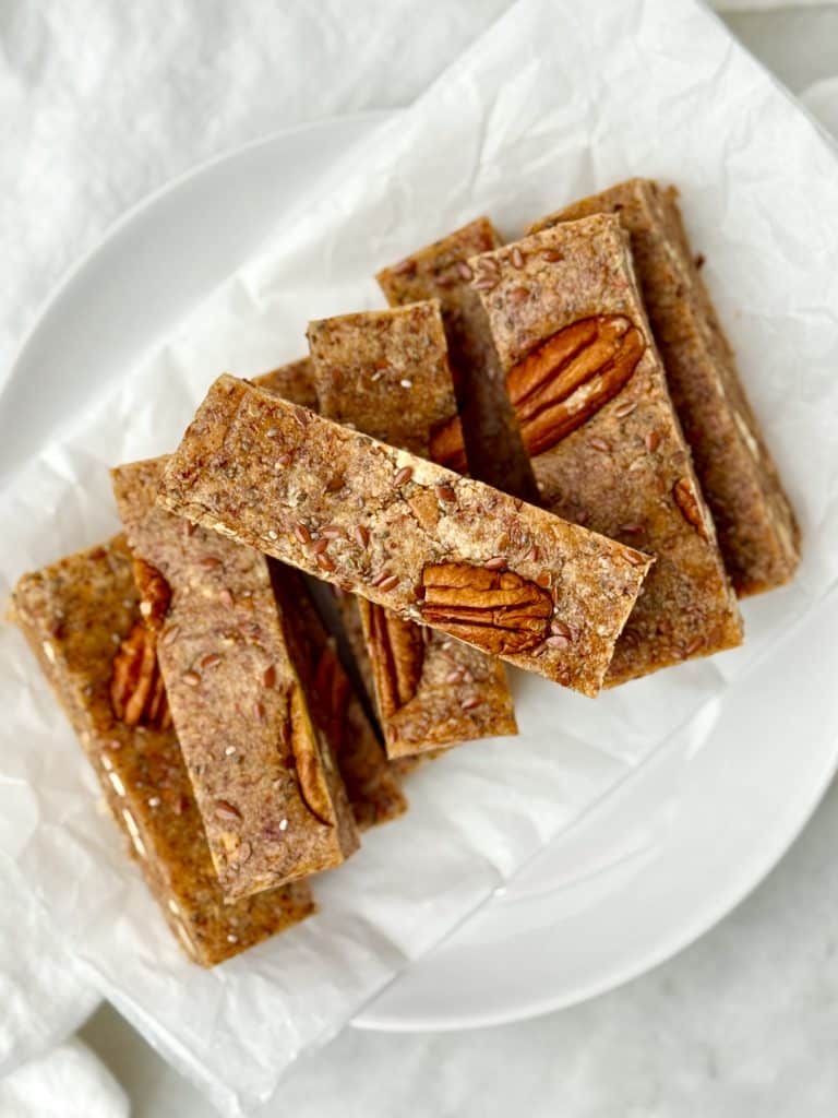 No-bake high-protein low-carb breakfast bars with chia seeds, flaxseed, and pecans on parchment paper
