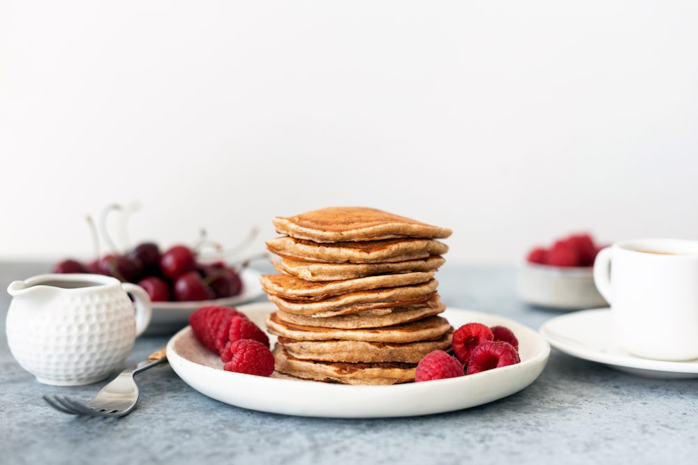 High protein low carb pancakes served with fresh raspberries.