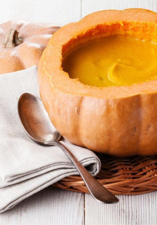 Creamy pumpkin soup served in a carved-out pumpkin bowl, a perfect addition to pumpkin recipes for fall.