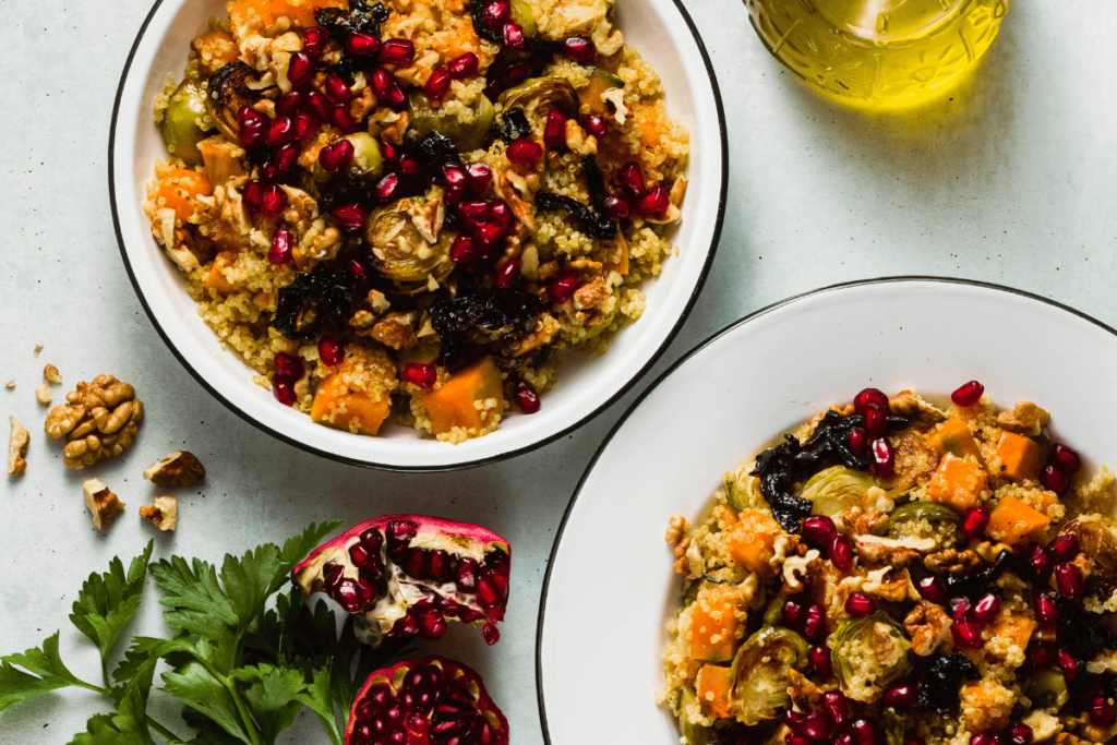 Healthy fall dinner bowl with quinoa, roasted vegetables, pomegranate seeds, and walnuts - perfect for cozy fall dinner ideas and healthy fall recipes.