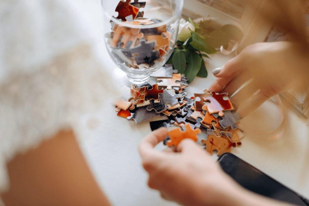 Hands assembling a puzzle as part of screen-free activities for adults.