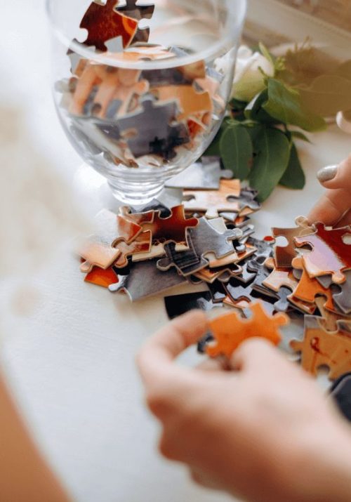 Hands assembling a puzzle as part of screen-free activities for adults.