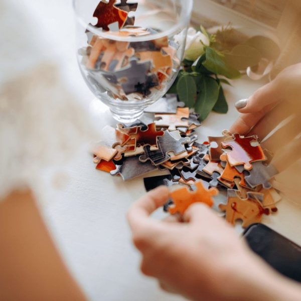 Hands assembling a puzzle as part of screen-free activities for adults.