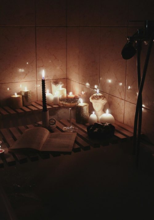 goal ideas for 2025 represented by a luxurious bath set on new years with a glass of champagne and a candle