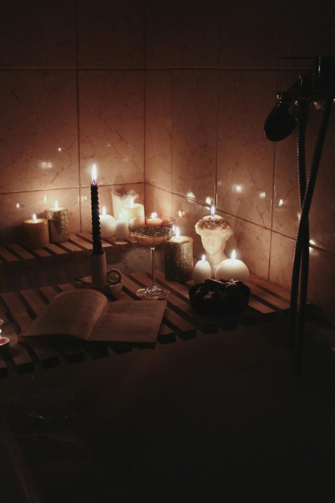 goal ideas for 2025 represented by a luxurious bath set on new years with a glass of champagne and a candle