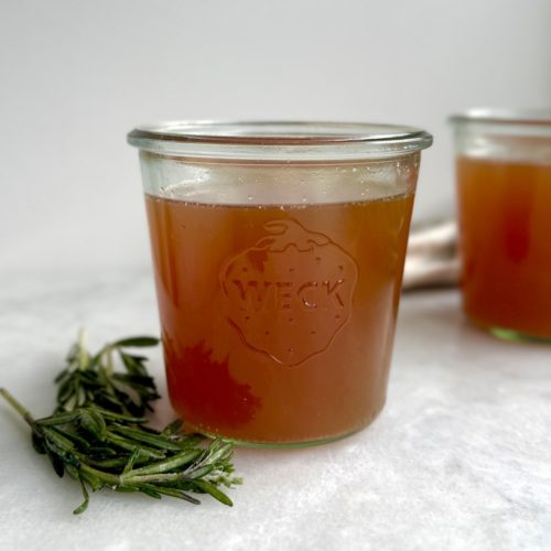 slow cooker bone broth in a glass container