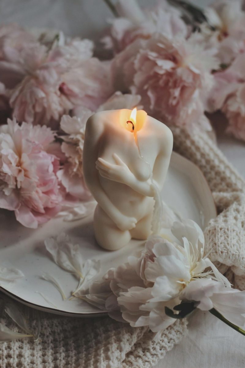 A candle shaped like a woman's body representing cycle syncing.