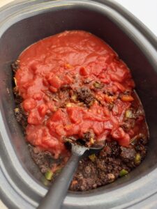 adding the tomato to crockpot chili recipe easy