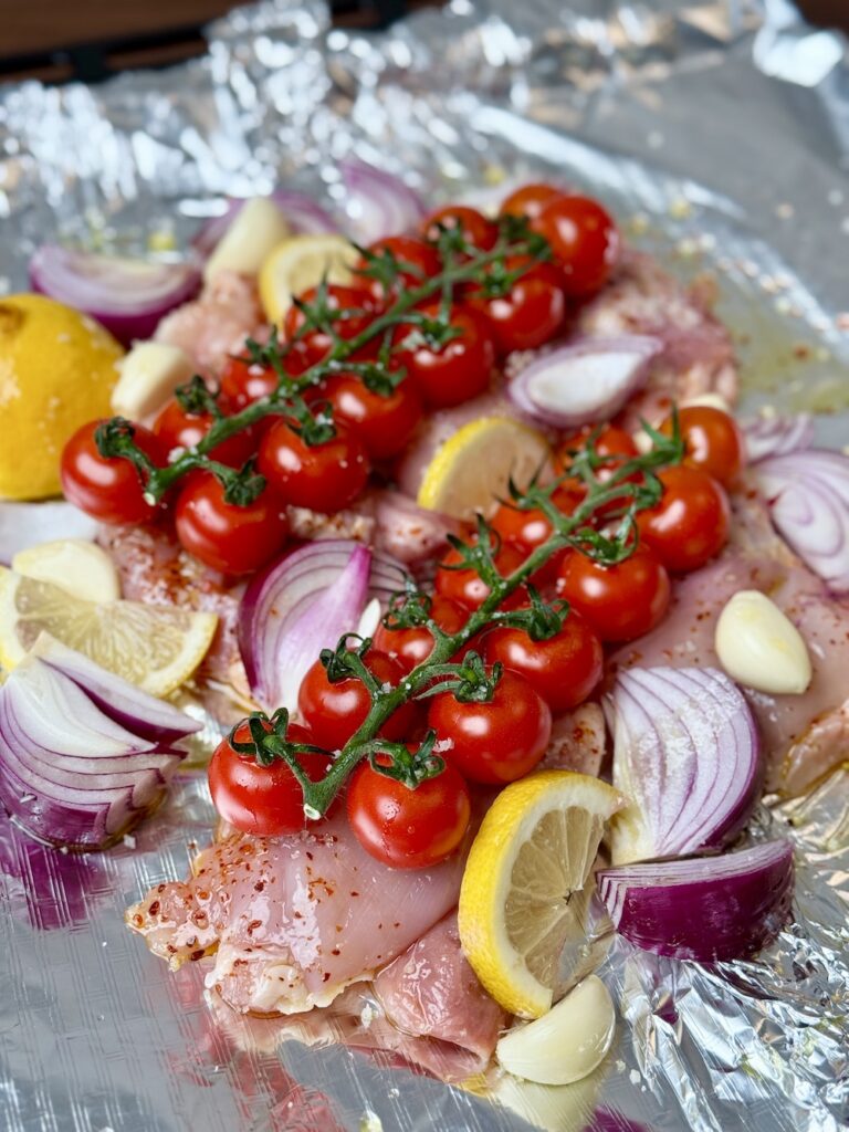 chicken sheet pan dinner ideas with chicken thighs, onion, garlic, and lemon