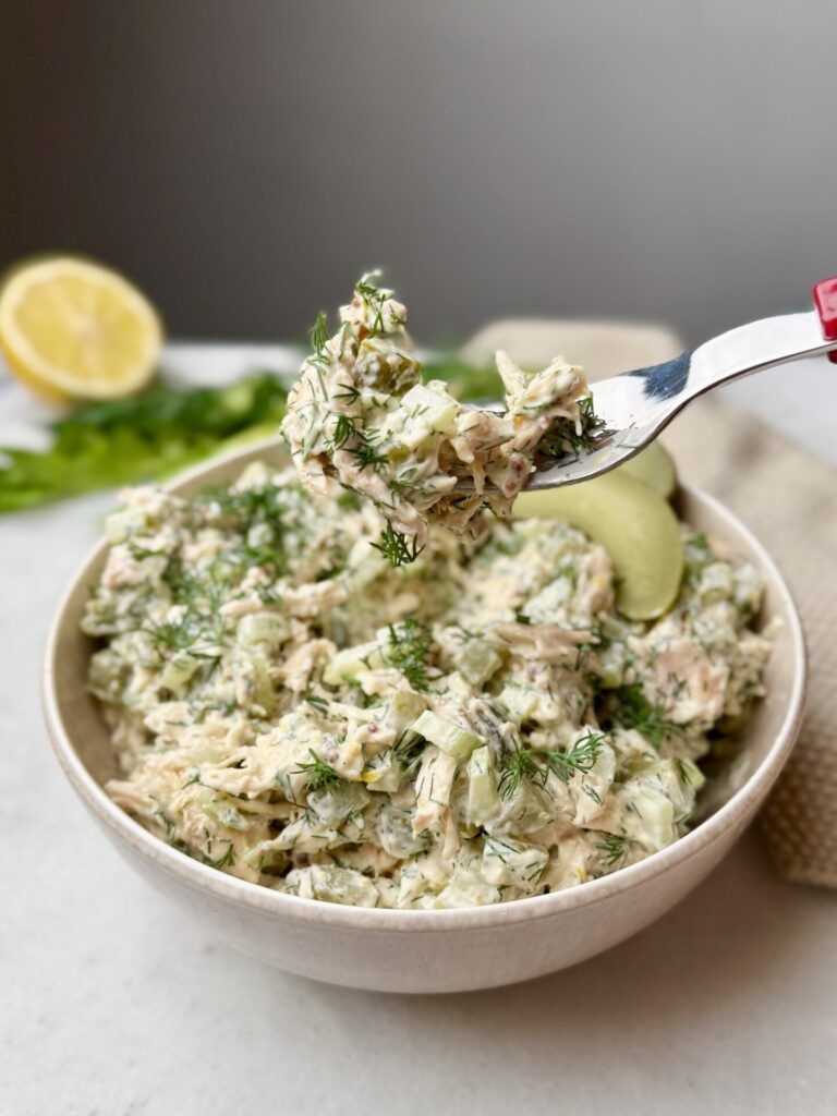 A forkful of creamy dill pickle chicken salad loaded with crunchy pickles, celery, and shredded chicken.