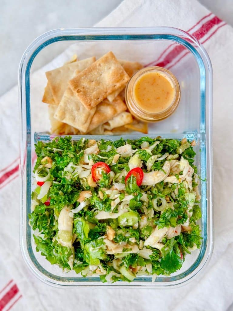 Houston's kale salad meal prep container with pita chips and peanut dressing