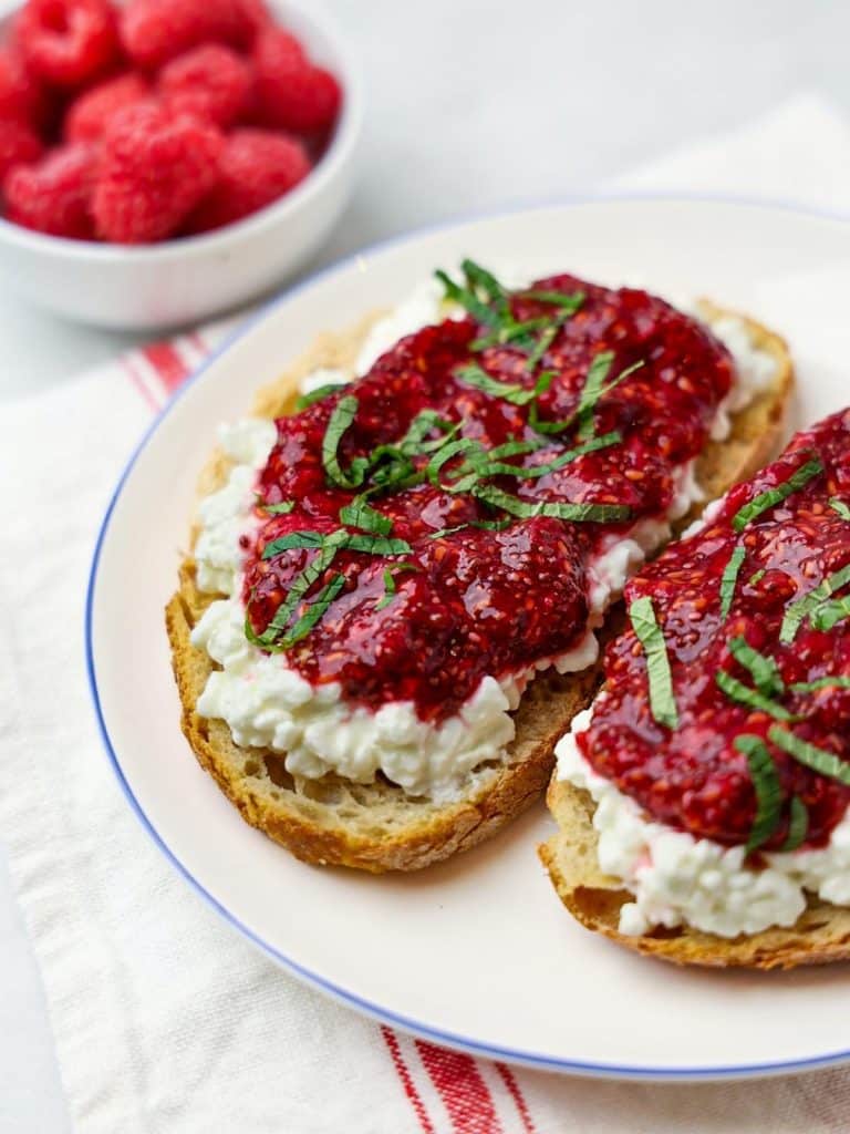 Cottage cheese toast topped with raspberry chia jam and fresh basil