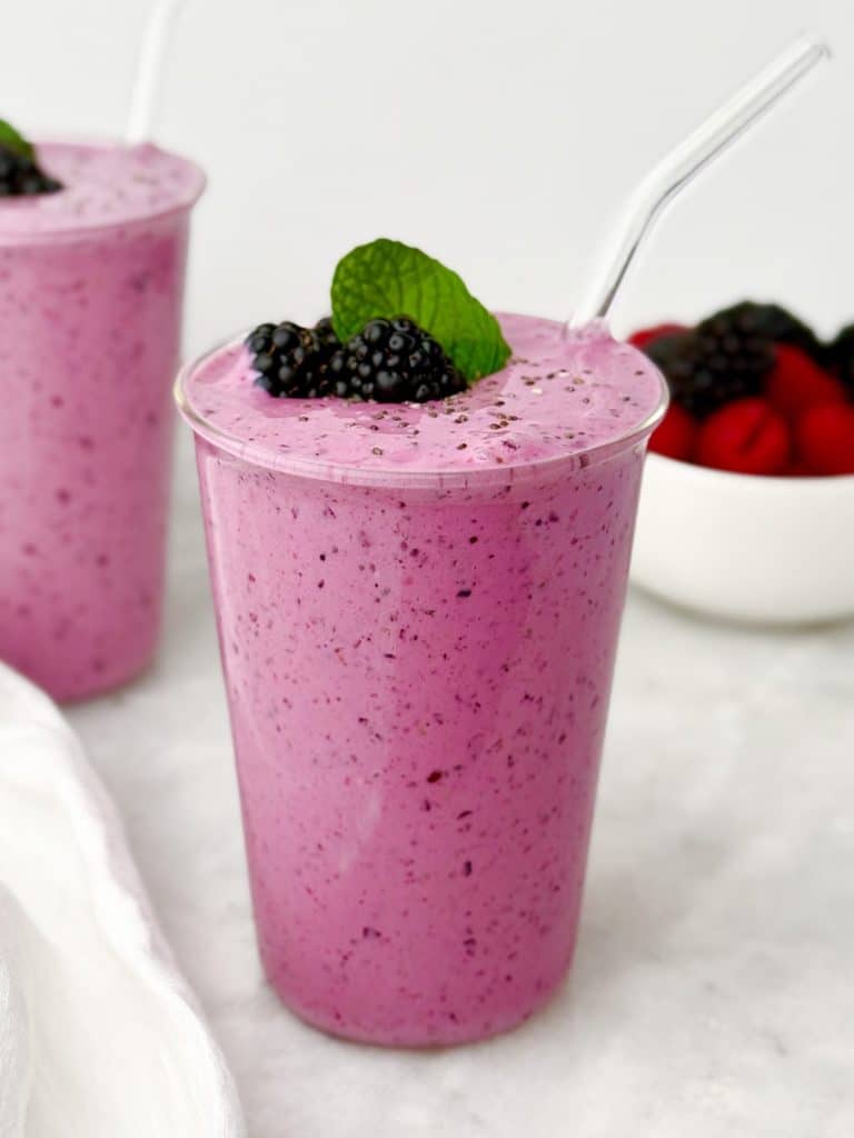 Berry protein smoothie topped with blackberries and mint
