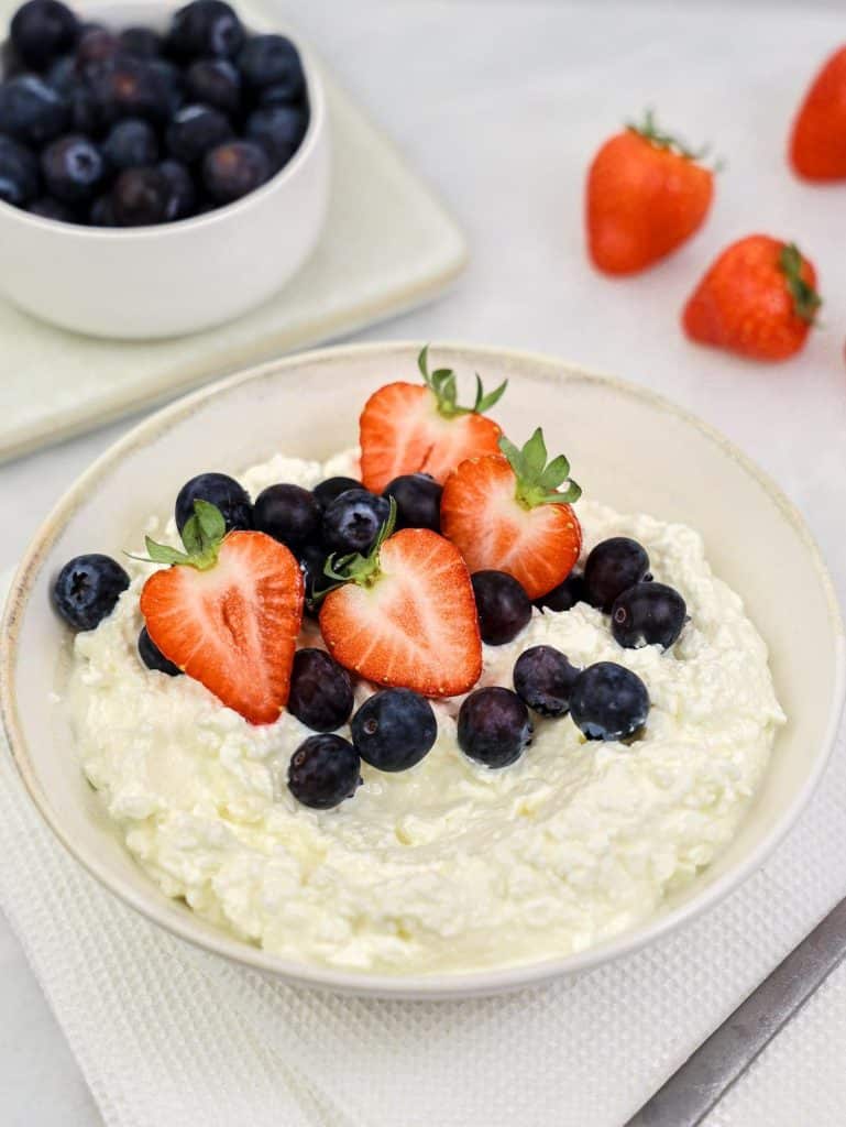 Easy high-protein breakfast cottage cheese bowl with fresh strawberries and blueberries