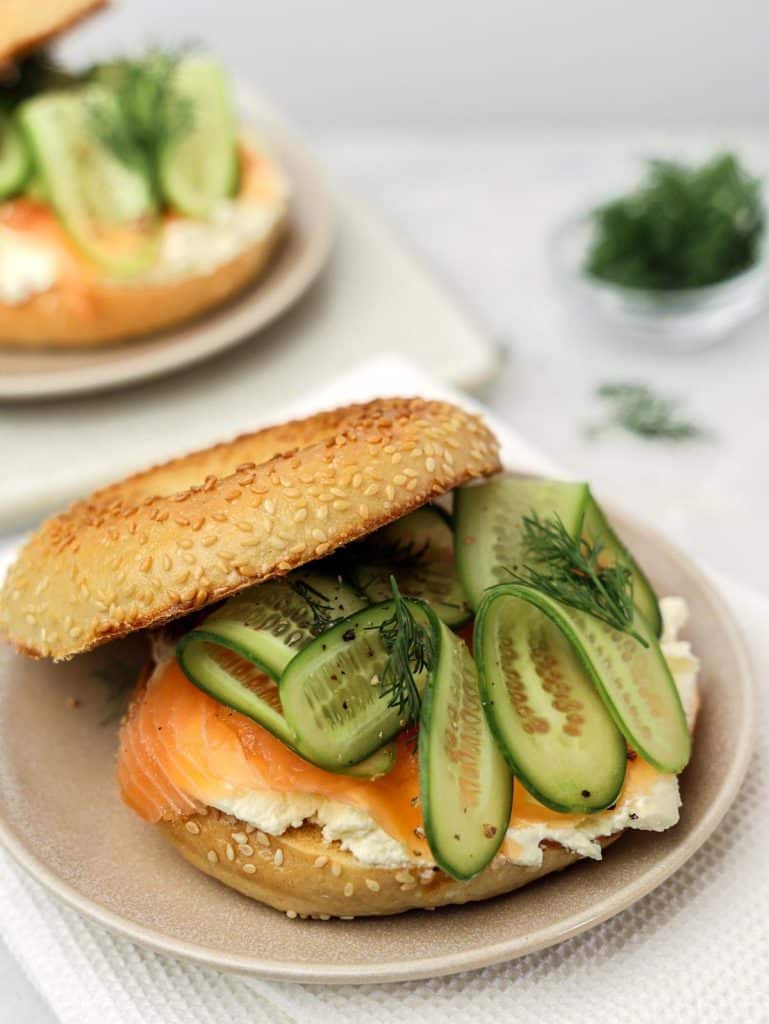 High-protein breakfast smoked salmon bagel with cream cheese, cucumber ribbons and fresh dill