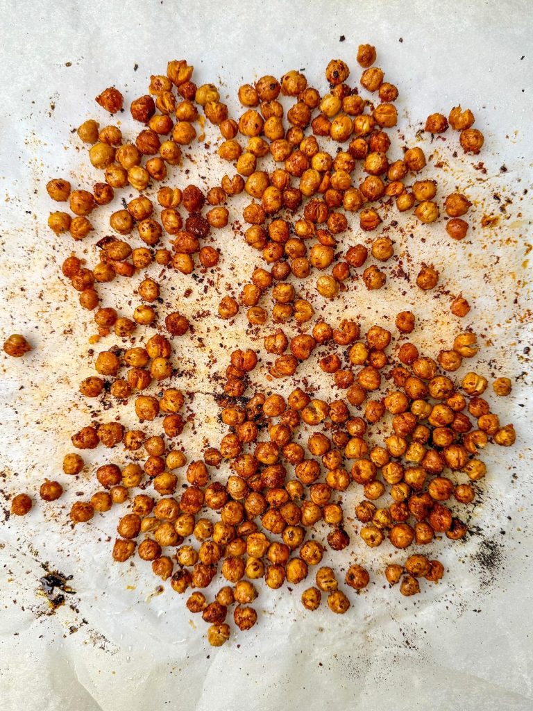 Crispy roasted chickpeas for high protein caesar pasta salad on parchment paper