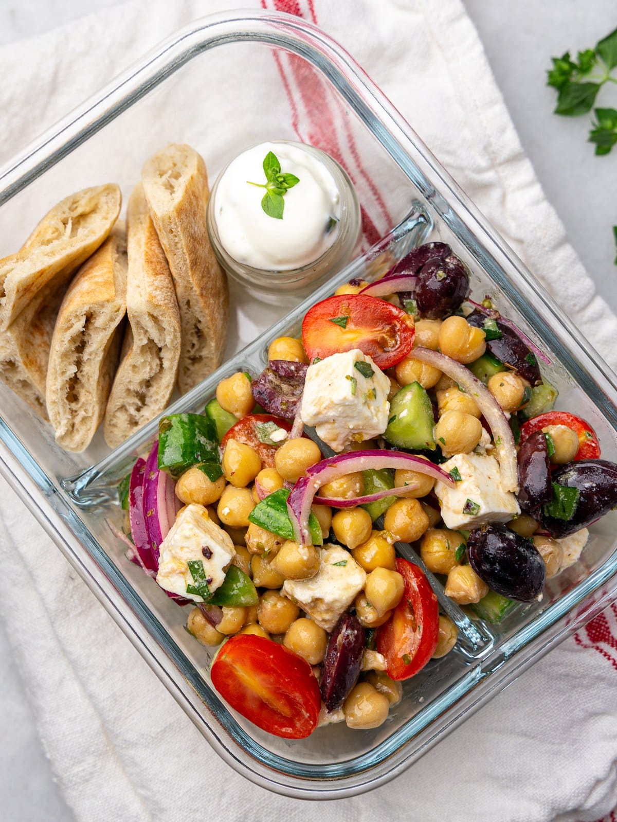 Greek chickpea salad lunch box with feta, olives, pita and tzatziki