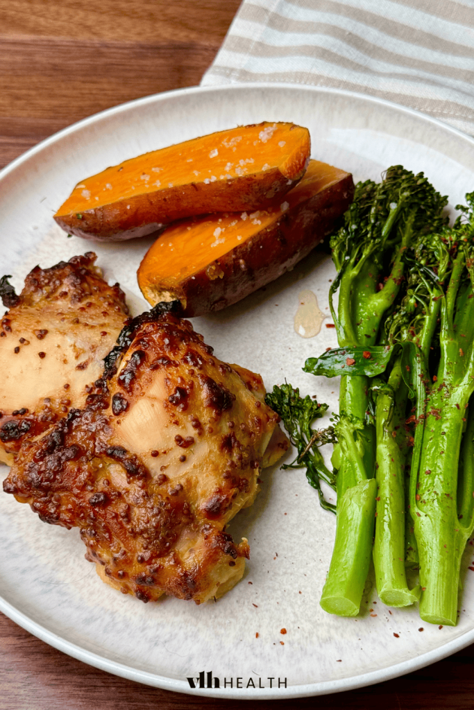 Honey mustard chicken thighs served with roasted sweet potatoes and broccoli