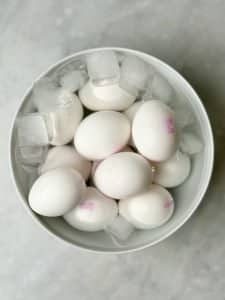 Hard-boiled eggs cooling in an ice bath to stop cooking and make peeling easier