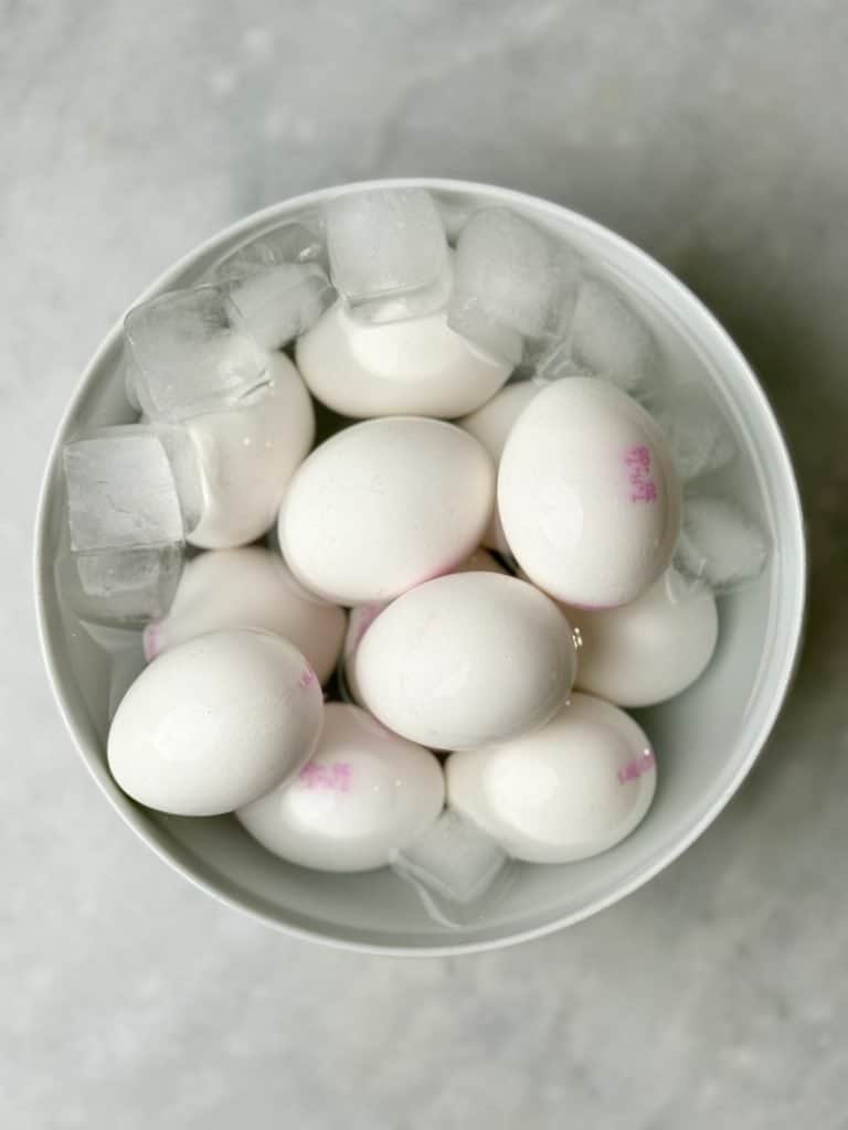 Hard-boiled eggs cooling in an ice bath to stop cooking and make peeling easier