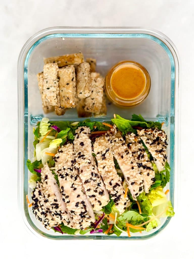 erewhone asian chicken salad in glass meal prep container.