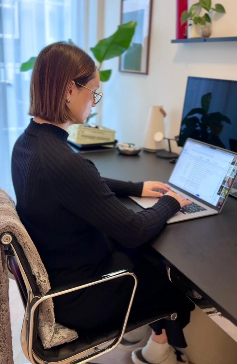 Me working at my laptop in a home office, building my website and learning how to make a blog that makes money from scratch.