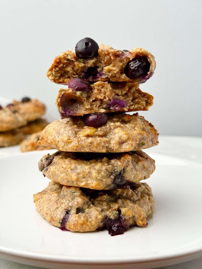 Stack of high protein blueberry breakfast cookies on a white plate. Soft, gluten-free, sugar-free cookies made with almond butter, collagen, and coconut.