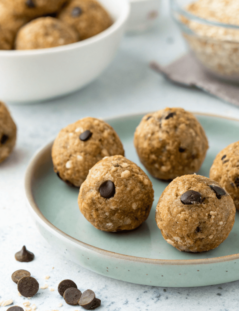 Plate of no-bake chocolate chip protein balls made with oats and nut butter, a quick high-protein snack on the go.