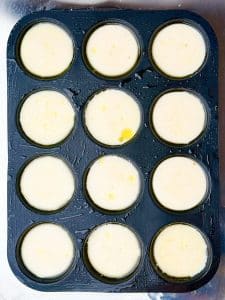 Smooth blended egg white mixture portioned into muffin tin for copycat Starbucks egg white bites before adding toppings.