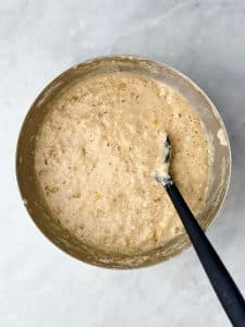Thick banana protein pancake batter mixed in a stainless steel bowl.