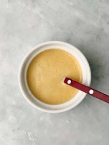 Homemade apple cider vinaigrette with Dijon mustard and maple syrup for drizzling over a fall lentil salad.