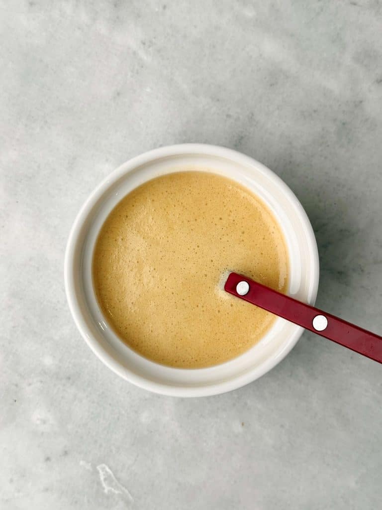 Homemade apple cider vinaigrette with Dijon mustard and maple syrup for drizzling over a fall lentil salad.