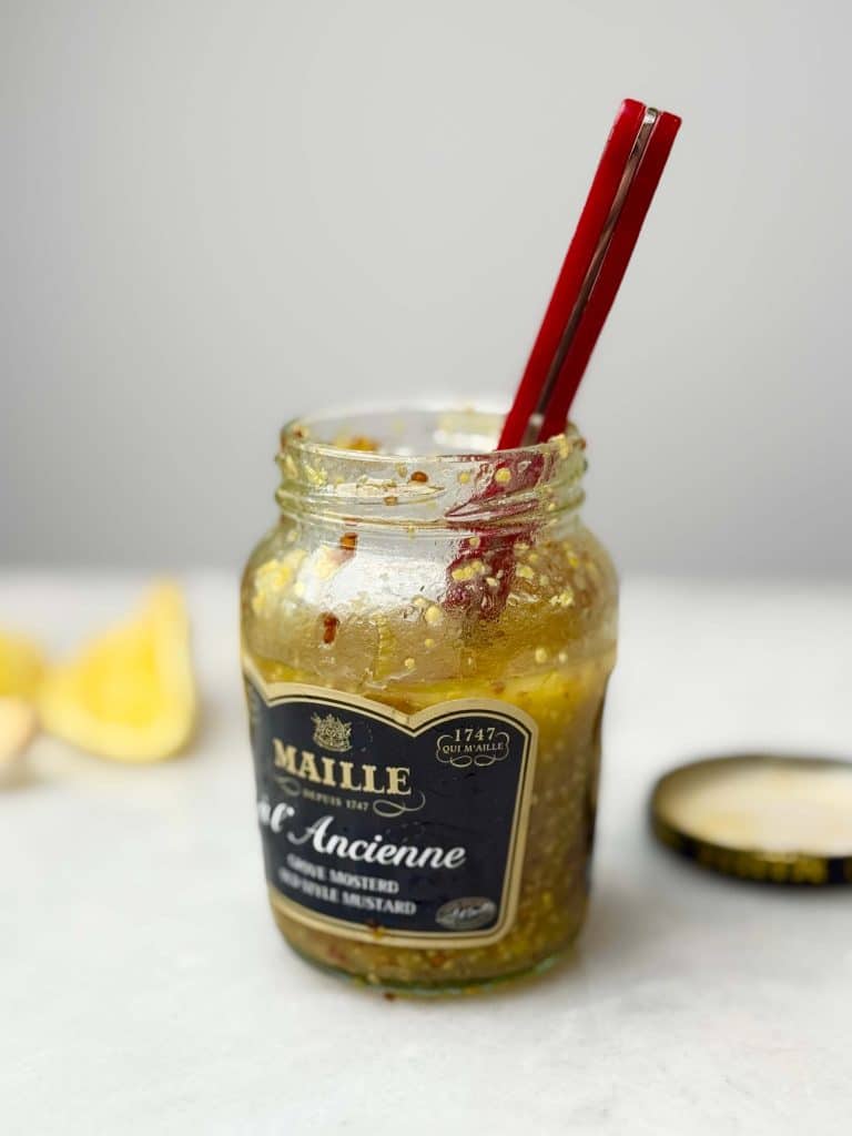Jar of Maille filled with brussel sprout salad dressing.