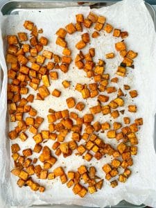 Diced sweet potatoes roasted with olive oil, smoked paprika, cumin, and coriander for a cozy fall lentil salad.
