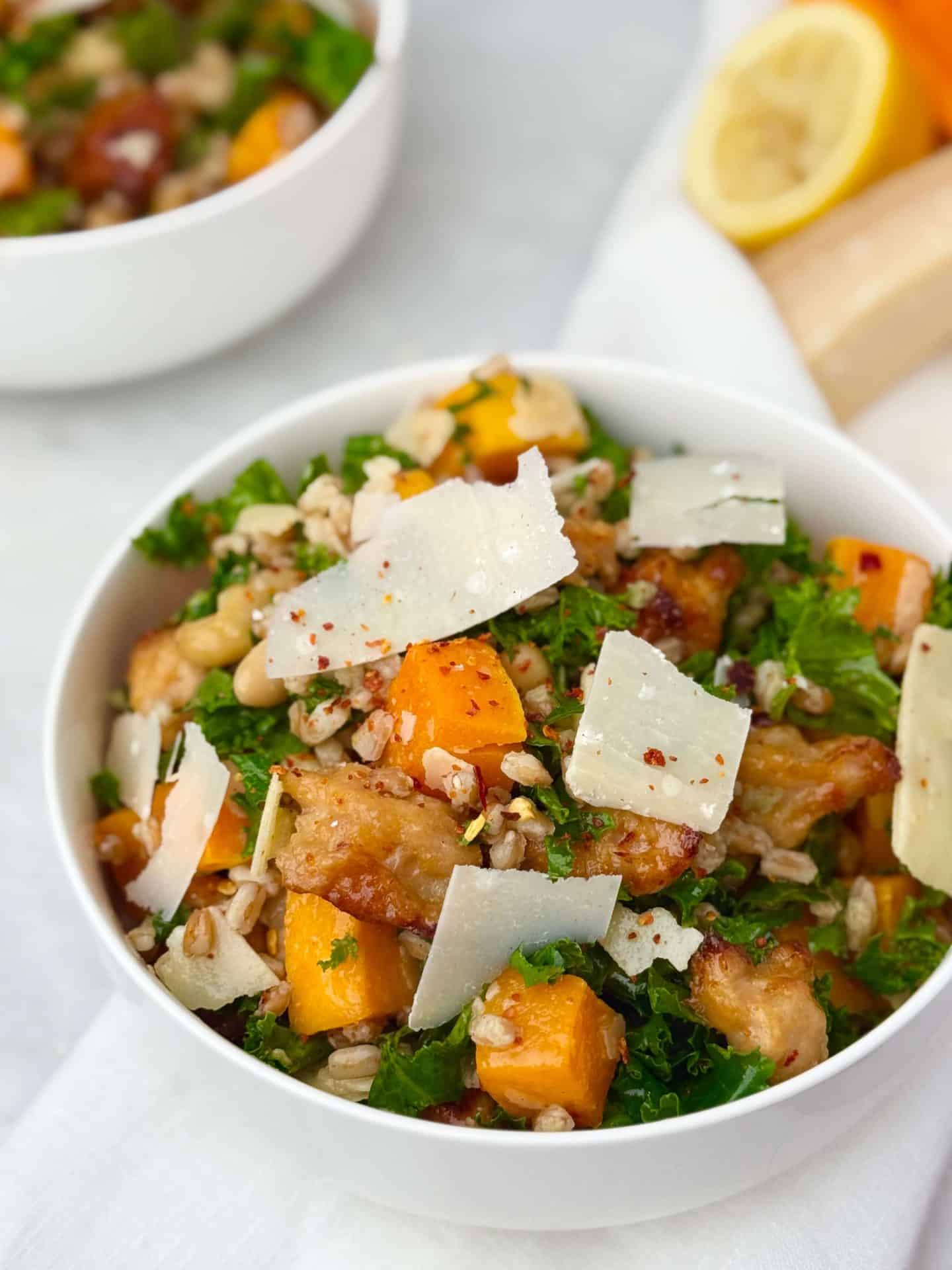 Close-up of fall farro salad with kale, white beans, and parmesan flakes.