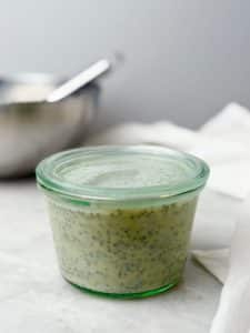 Glass jar filled with freshly mixed dairy free chia seed pudding before refrigerating to set.