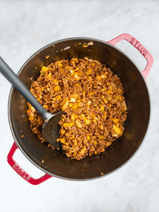 Ground beef browned with onions and tomato paste to build the base of creamy lasagna soup.
