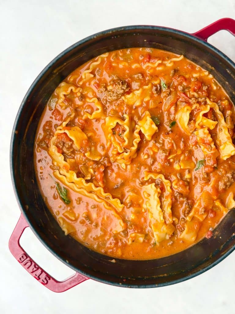 Dutch oven filled with creamy high-protein lasagna soup made with crushed tomatoes and lasagna noodles.